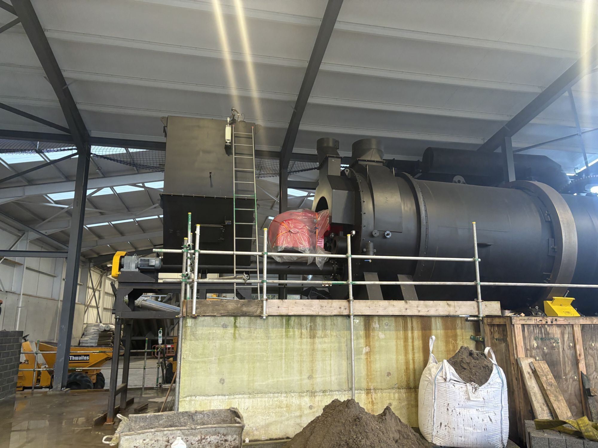 Industrial processing plant installed inside a steel-framed shed