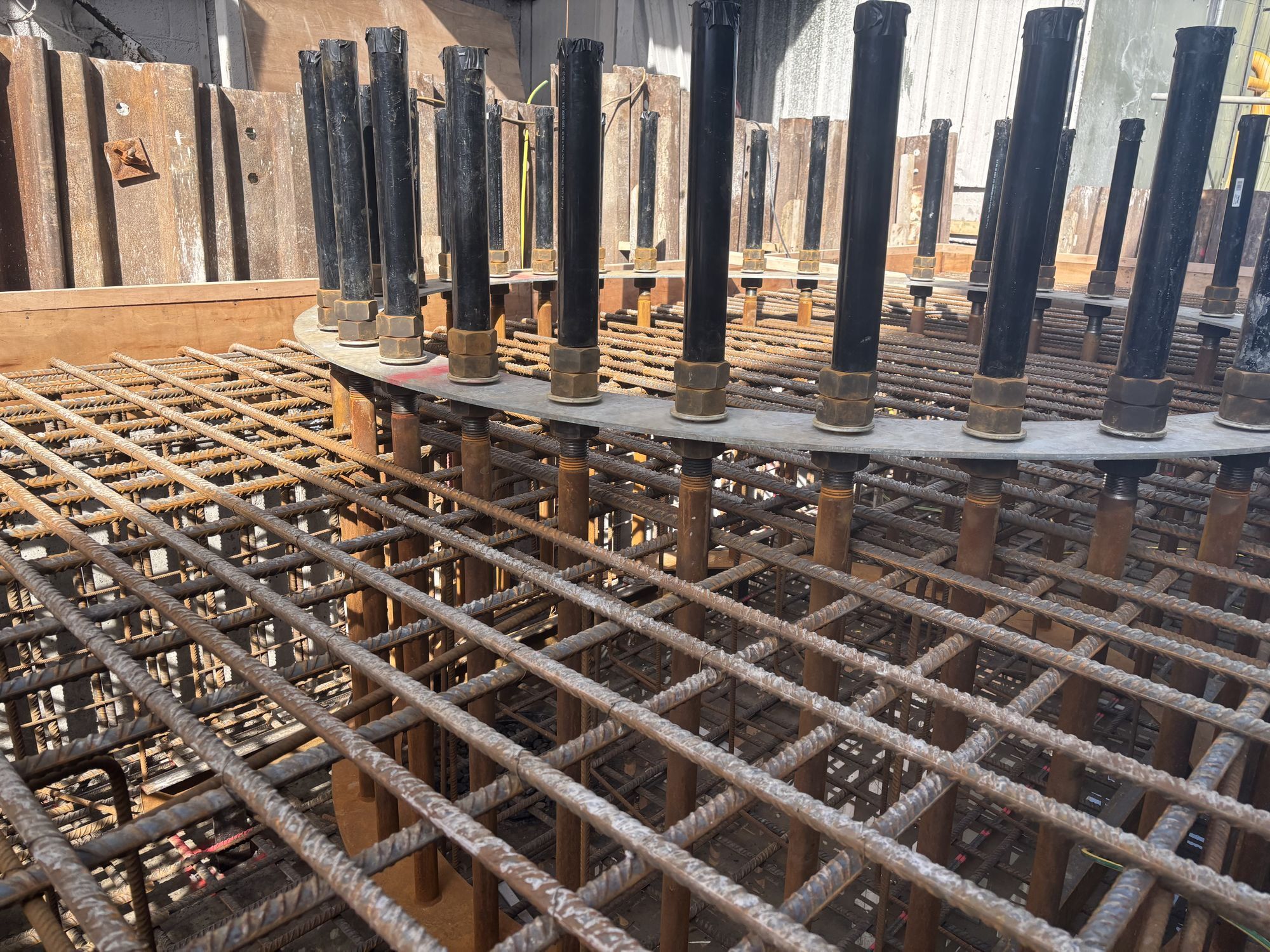 Steel reinforcement cage with anchor bolts set for a foundation